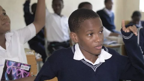 School students learning ,writing and listening to teacher in the classroom Stock Footage 250820878