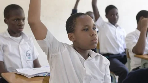 School students learning ,writing and listening to teacher in the classroom Stockbeeldmateriaal 250820886