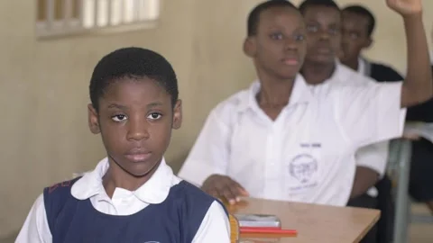 School students learning ,writing and listening to teacher in the classroom Vidéo 250824116