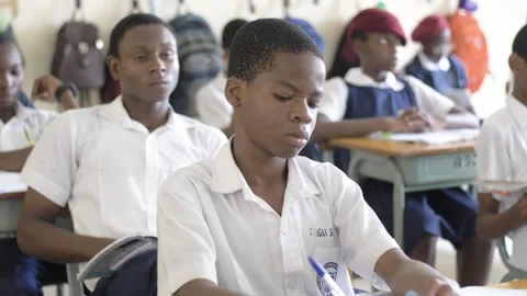 School students learning ,writing and listening to teacher in the classroom Stockbeeldmateriaal 251635859