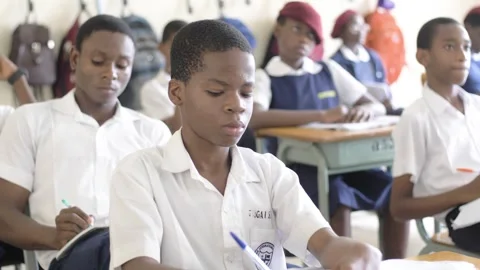 School students learning ,writing and listening to teacher in the classroom Stockbeeldmateriaal 251636612