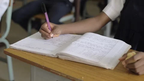 School students learning ,writing and listening to teacher in the classroom Stockbeeldmateriaal 251636615