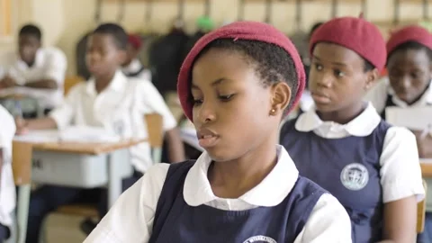 School students learning ,writing and listening to teacher in the classroom Stock Footage 251636621