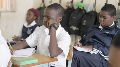 School students learning ,writing and listening to teacher in the classroom Stock Footage 251638278
