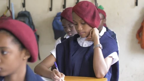 School students learning ,writing and listening to teacher in the classroom Stockbeeldmateriaal 251638919
