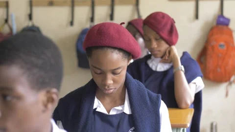 School students learning ,writing and listening to teacher in the classroom Stock Footage 251650862
