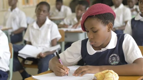 School students learning ,writing and listening to teacher in the classroom Stockbeeldmateriaal 251652428