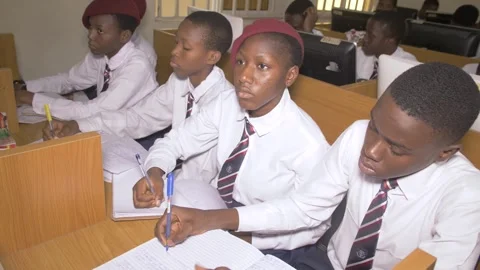 School students learning ,writing and listening to teacher in the classroom Stock Footage 252307237