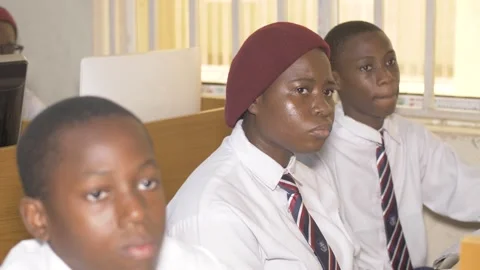 School students learning ,writing and listening to teacher in the classroom Vidéo 252309531