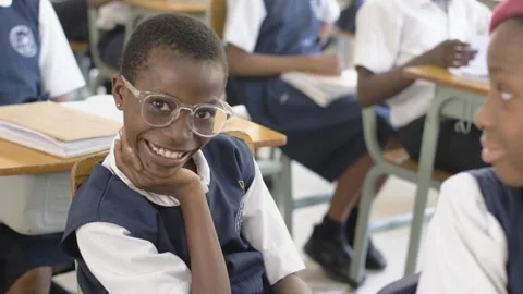 School students learning ,writing and listening to teacher in the classroom Stock Footage 252362555