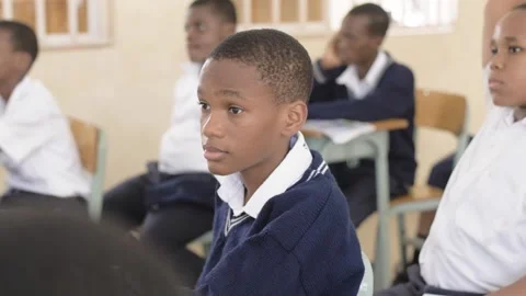 School students learning ,writing and listening to teacher in the classroom Stock Footage 252362593