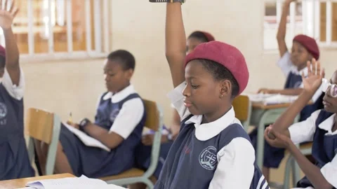 School students learning ,writing and listening to teacher in the classroom Stock Footage 252363301