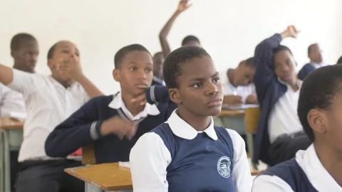 School students learning ,writing and listening to teacher in the classroom Stock Footage 252363330