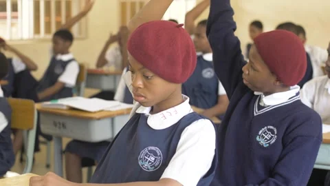 School students learning ,writing and listening to teacher in the classroom Stock Footage 252363367