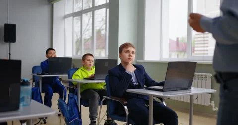 School Students Listening To Teacher In Classroom, Teen Boys Sitting At Tables Stock Footage 280174403