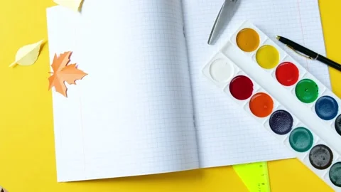 School supplies are spinning clockwise on a bright yellow background. Stock Footage 204974084