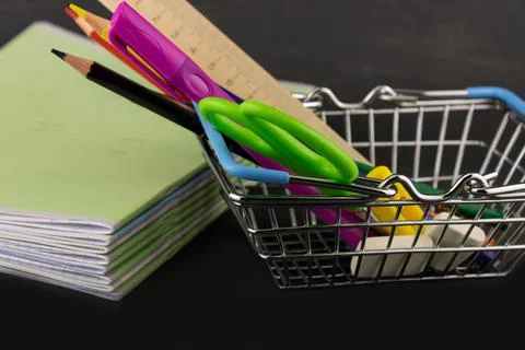 School supplies in the basket and a stack of notebooks Stock Photos