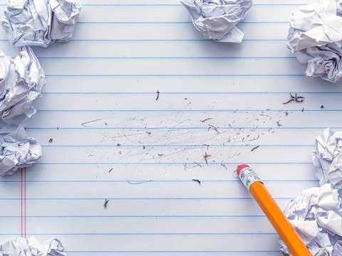 School supplies of blank lined notebook paper with eraser marks and erased .. Stock Photos