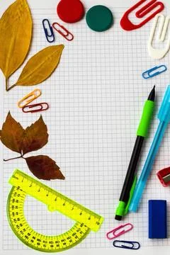 School supplies on checkered notebook Stock Photos
