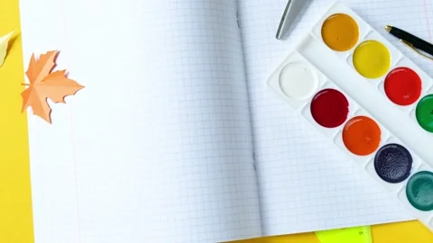 School supplies rotate clockwise and zoom in on a bright yellow background. Stock Footage 204974076