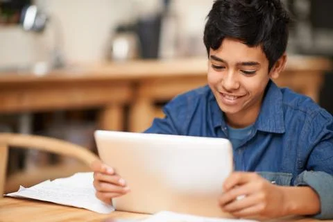 School, tablet and boy in classroom with smile learning, internet website and Stock Photos