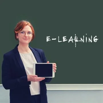 School teacher and the text "e-learning" is written on the blackboard, the co Stock Photos