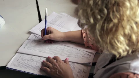 School Teacher Checking Attendance in Grade Book, Public School Classroom, 4K Stock Footage 327297208