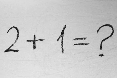 School teacher is drawn math formulas on the white chalkboard via black chalk Stock Photos