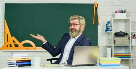 School teacher programming laptop. Learn programming language. Handsome man use Foto stock