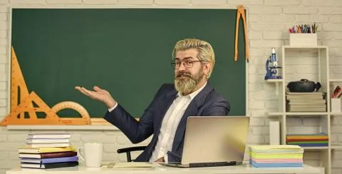 School teacher programming laptop. Learn programming language. Handsome man use Foto stock