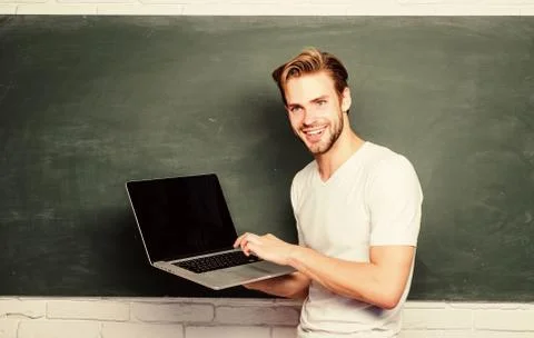 School teacher programming with laptop. Student learn programming language 库存照片