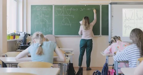 School Teacher Writing Math Formula on the Board Stock Footage 97339774