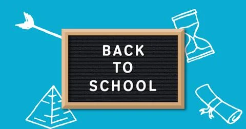 School-themed image: BACK TO SCHOOL on blackboard against blue background Stock Photos