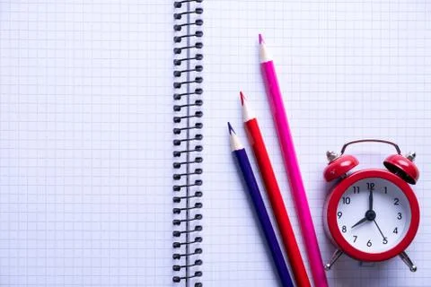 School time minimalistic concept. Colored pencils and notebooks Stock Photos