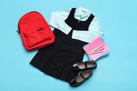 School uniform with a red backpack, notebooks, and shoes for back to school p Stock Photos