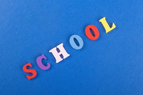 SCHOOL word on blue background composed from colorful abc alphabet block wo.. Stock Photos