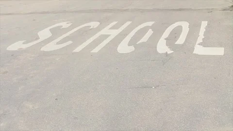 School word caption text printed on road street in white capital letters Stock Footage 248713537