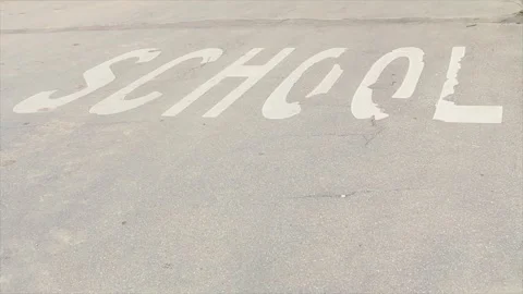 School word caption text printed on road street in white capital letters Stock Footage 248713587