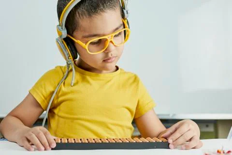Schoolboy with abacus. Young kid training mental arithmetic Stock Photos