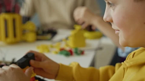 Schoolboy Assembling Robot Model in Stem Education Class Stock Footage 340549819
