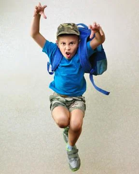Schoolboy with backpack jumping and running Stock Photos