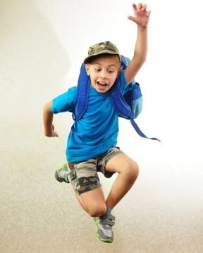 Schoolboy with backpack jumping and running Stock Photos
