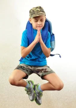 Schoolboy with backpack jumping and running Stock Photos