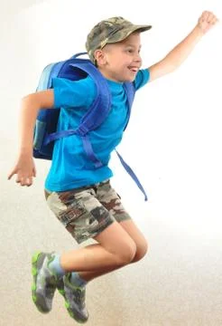 Schoolboy with backpack jumping and running Stock Photos