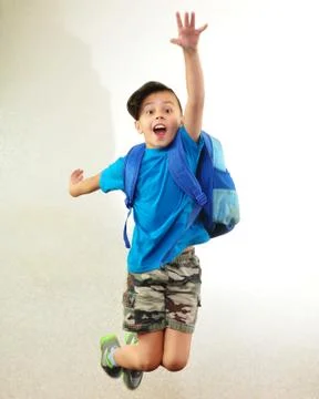 Schoolboy with backpack jumping and running Stock Photos