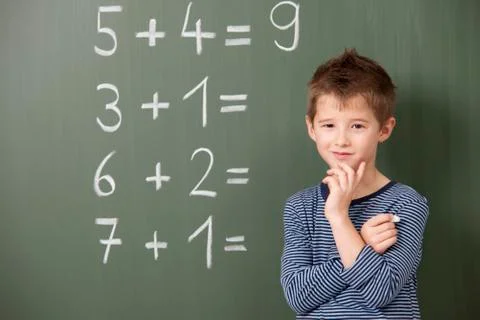 Schoolboy at blackboard with arithmetic problems Stock Photos