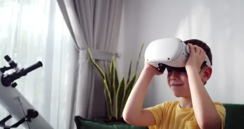 Schoolboy boy puts on virtual glasses and immerses himself in cyberspace Stock Footage 262975044