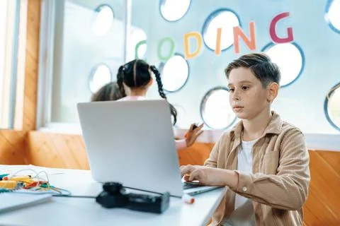 The schoolboy in classroom sitting and learn engineering with laptop. Erudition. Stock Photos