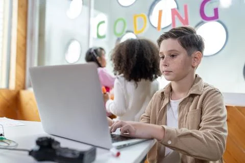 The schoolboy in classroom sitting and learn engineering with laptop. Erudition. Stock Photos