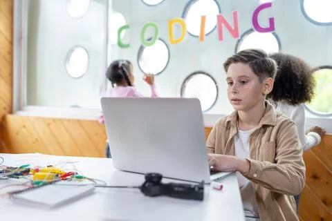 The schoolboy in classroom sitting and learn engineering with laptop. Erudition. Stockfoto's